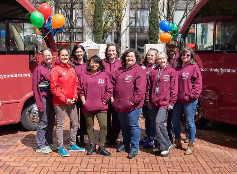 A mobile clinic team gathered together outside their unit