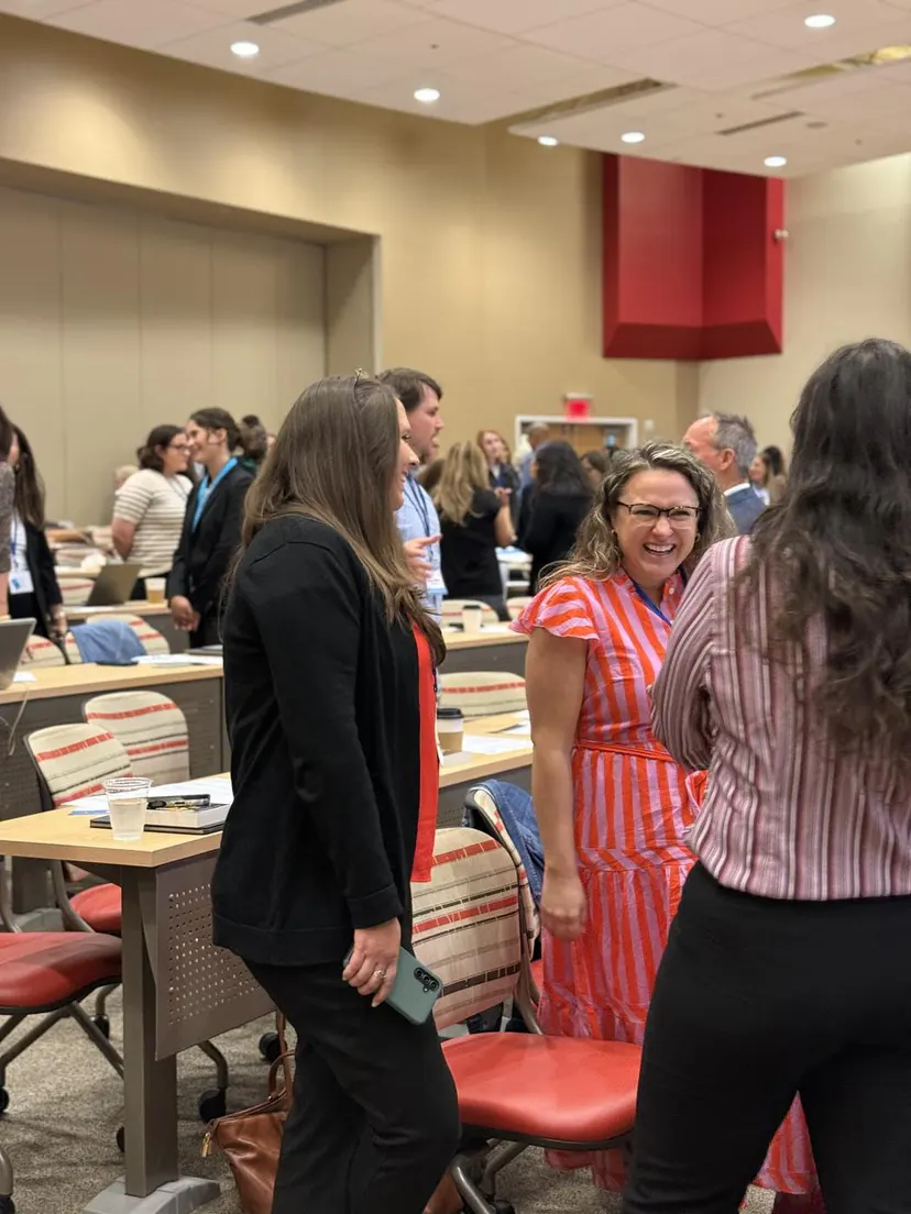 Attendees laughing together during a break