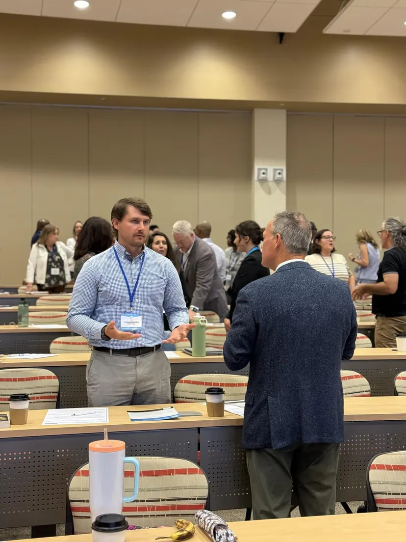 Attendees talking beside the session tables