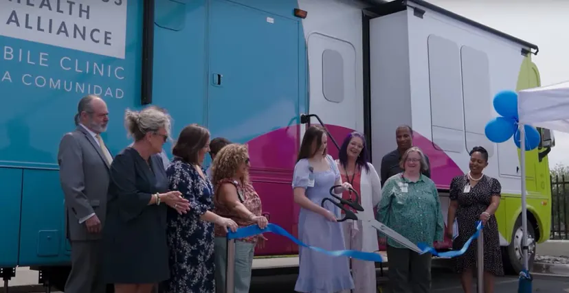 Staff and community members at a mobile health ribbon cutting