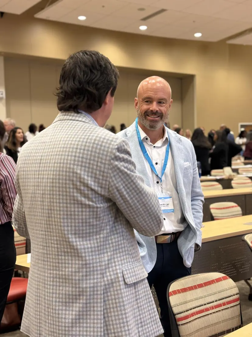 Two attendees catching up before the opening session